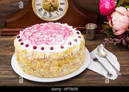 Sponge cake with almonds, whipped cream and berries. Studio Photo Stock Photo
