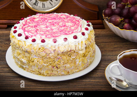 Sponge cake with almonds, whipped cream and berries. Studio Photo Stock Photo