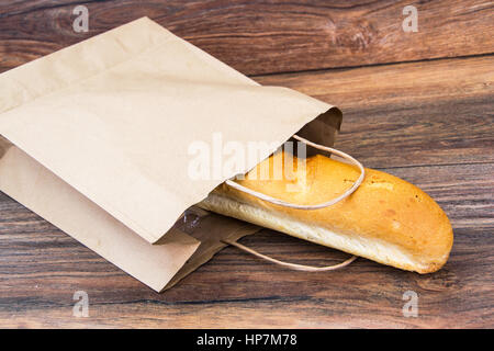 Fresh warm baguette in paper bag. Studio Photo Stock Photo