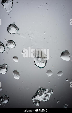 frozen raindrops on glass with blur background and gradient Stock Photo