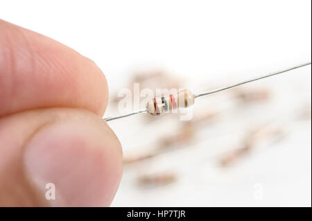 closeup 1K or 1000 Ohms resistor on the finger Stock Photo