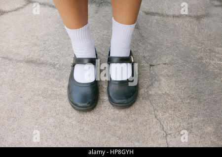 Thai girl Student shoes at concrete background Stock Photo