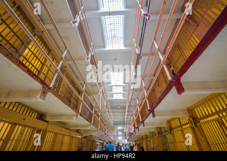 San Francisco, California, United States - August 14, 2016: tourists visiting Alcatraz prison in main corridor upper cells on both sides on three leve Stock Photo