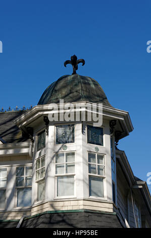 Close-up of an ornate cupola with French fleur-de-lis finial on a Queen Anne Revival style house in Vancouver, British Columbia, Canada Stock Photo