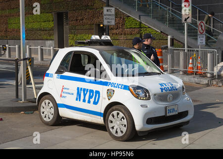 NYPD Counterterrorism Bureau officers, using a new Smart Fortwo smart car, provide security at the World Trade Center site in New York City. Stock Photo