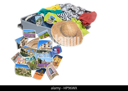 Studio shot of a suitcase with scattered clothing and straw hat. Photos of Provence landmarks are lying in front of the suitcase. Everything is on a w Stock Photo