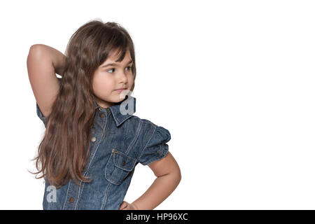Portrait in half of the body of long haired brunette little girl isolated on the white background. Girl is looking sideways into the free place ready  Stock Photo