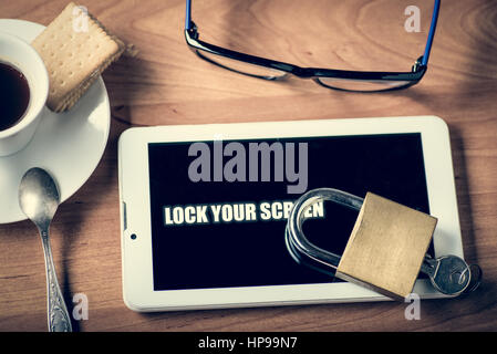 Tablet and padlock on the screen warning to lock you screen Stock Photo
