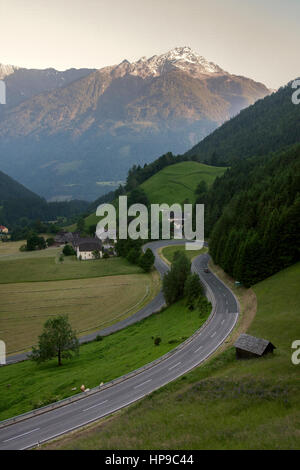 Alpine road in Austrian Alps in spring with snowy peaks in the background, Mallnitz, Austria Stock Photo