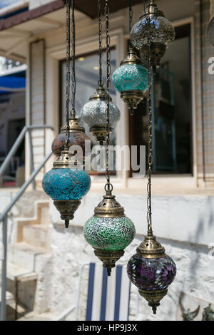 seven traditional turkish glass mosaic hanging lamps  of turquoise green purple and grey color over blurred background Stock Photo