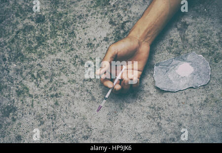 drug addict man with syringe in action Stock Photo