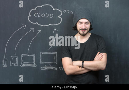 Portrait of man with cloud computing diagram on the chalkboard. Cloud Computing Concept on Chalkboard Stock Photo