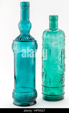 Two green / blue glass bottles blown from recycled glass in Spain isolated Stock Photo