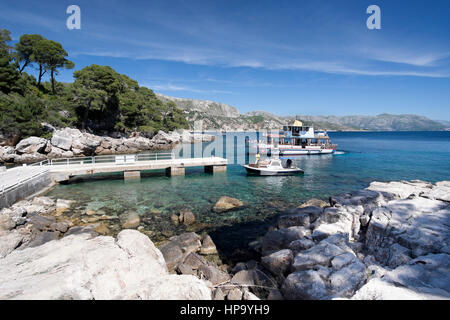 A passenger ferry arrives at the dock on Lokrum Island, near Dubrovnik, Croatia Stock Photo