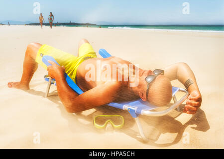 Man at the beach on a windy day. Stock Photo