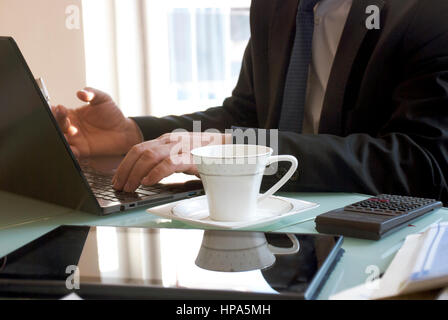 Businesman working from home on a with laptop computer Stock Photo