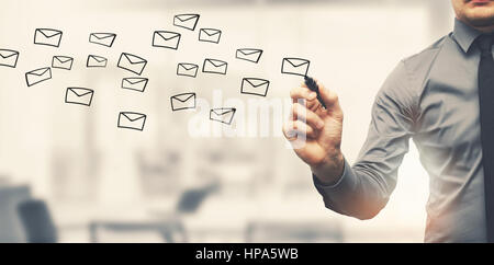 sending email concept - businessman drawing envelopes in offiice Stock Photo