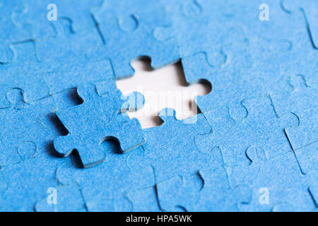 problem solved concept - placing last piece of jigsaw puzzle Stock Photo