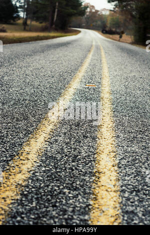 Off-centered view of a gravel road. No passing. Stock Photo