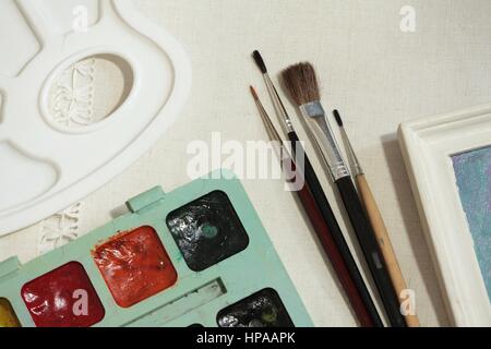 paint on canvas and brush tools artist Stock Photo