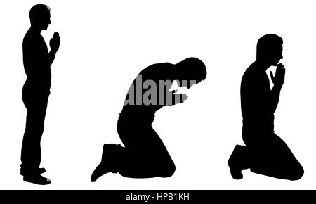 A christian catholic man kneeling and praying on the side altar of ...