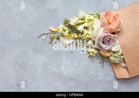 envelope with flowers on the stone gray background. flat lay Stock Photo