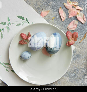 Easter place setting with easter eggs and leaves and flowers, Stock Photo