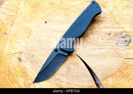 Pocket knife with a black blade. Casual knife. Stock Photo
