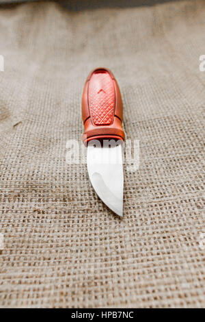 Sharp knife on a background of burlap. Stock Photo