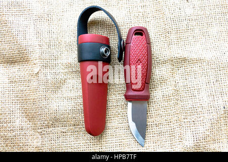 Hunting knife with a fixed blade on the sack. Knife on the background of sacking. Stock Photo