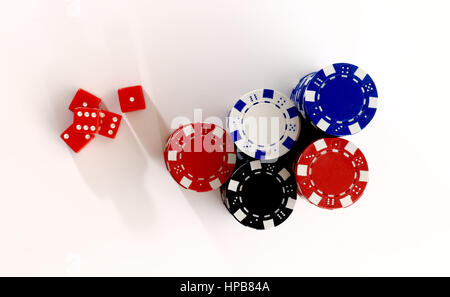 Red dice and casino chips from above. Dice and color chips over white background. Online casino concept. Stock Photo