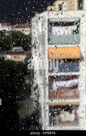 Crowd of clear rain drops on the window glass surface Stock Photo