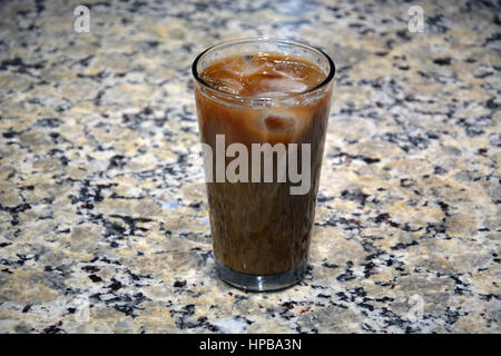 Glass of iced coffee on the kitchen counter. Stock Photo