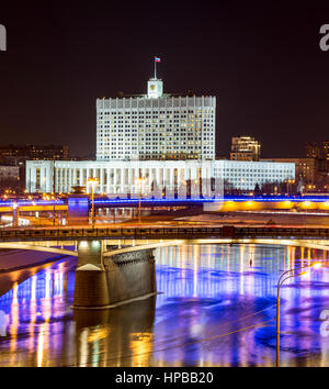 Night winter panorama of the House of Government of Russian Federation, road and metro bridges across the Moscow River. Rich illumination and reflecti Stock Photo