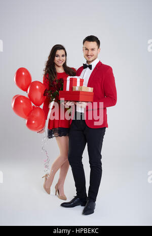 Handsome young man delighting his woman with gifts Stock Photo