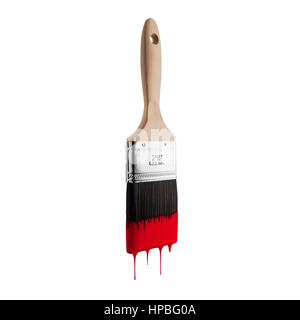 Paintbrush loaded with red color dripping off the bristles. Isolated on white background. Stock Photo