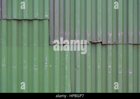 Old green corrugated metal cladding on a building Stock Photo