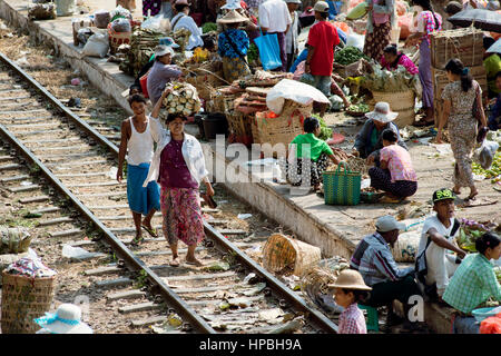 Large market on the station platform and along the rail track.  February 22, 2014 - Danyingon Railway Station, Yangon, Myanmar Stock Photo