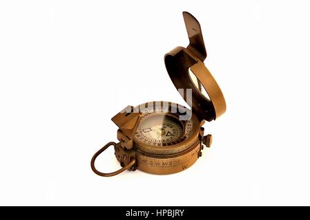 Old magnetic copper compass with light reflections on  glass cover isolated on white background Stock Photo