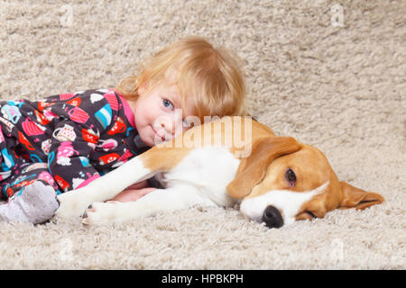tired of playing together beagle from little gorl child Stock Photo