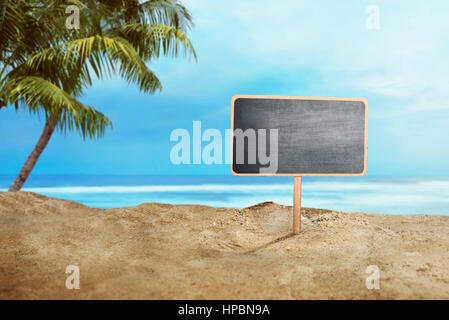 Blank wooden sign on sand at the beach Stock Photo