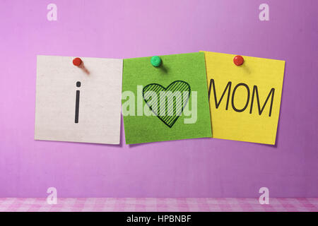 Happy Mothers Day message written on note paper in pink wall background Stock Photo