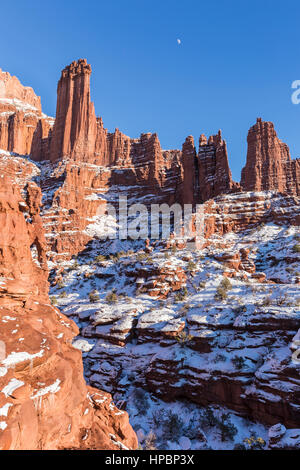 Afternoon moon rises over the Fisher Towers rock formations near Moab, Utah Stock Photo