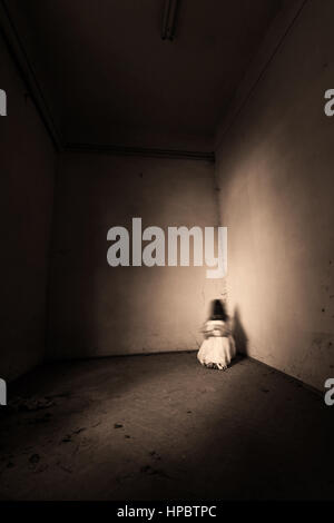 Horror ghost girl appears in an old building. Creepy movie scene Stock Photo