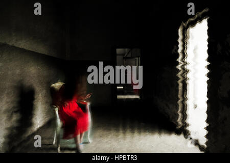 Horror ghost girl appears in an old building. Creepy movie scene Stock Photo
