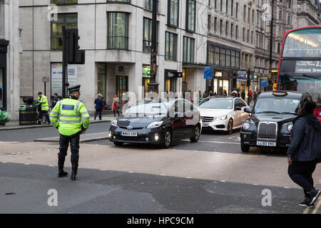 London, UK. 21st February, 2017. Police officers control traffic and pedestrians at a major intersection between the Strand, Aldwych and Waterloo Bridge where all traffic lights were simultaneously stuck on red. Credit: Mark Kerrison/Alamy Live News Stock Photo