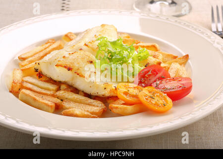 Baked fish and chips on elegant plate Stock Photo