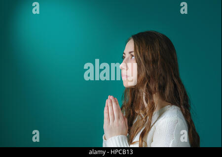 young woman praying in the room Stock Photo