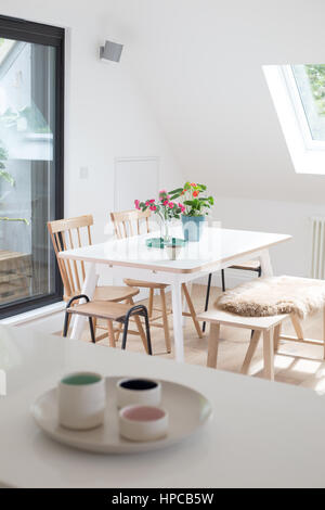 Bright contemporary dining table viewed from kitchen Stock Photo