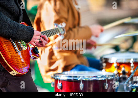 Festival music band. Friends playing on percussion instruments city park. Stock Photo